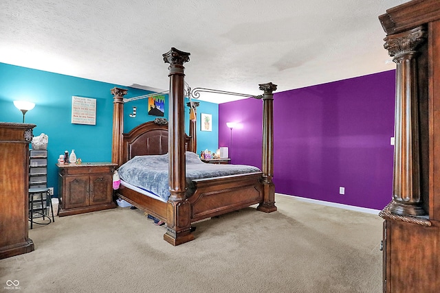 bedroom with ornate columns, carpet, baseboards, and a textured ceiling