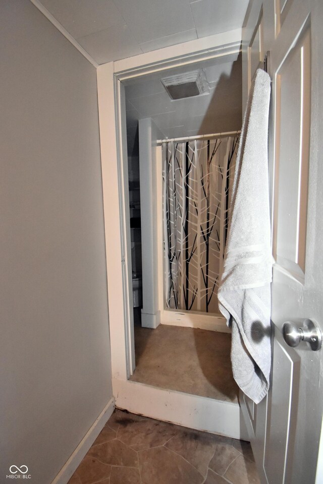 bathroom with tile patterned flooring, visible vents, and baseboards