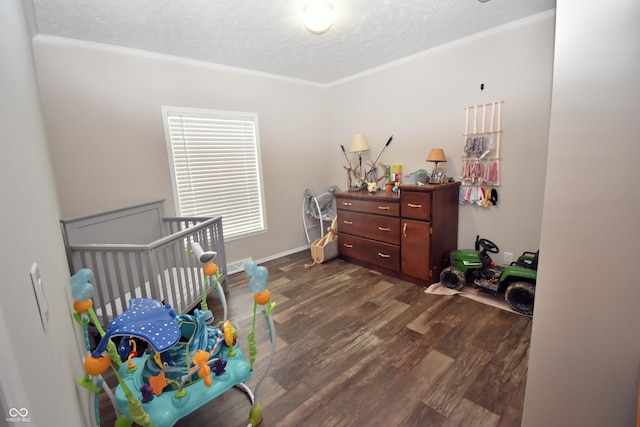 bedroom featuring a textured ceiling, dark wood-style flooring, baseboards, and crown molding