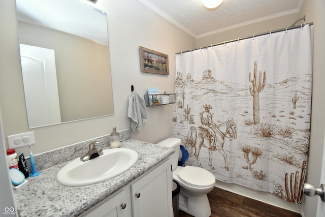 full bathroom featuring a textured ceiling, toilet, wood finished floors, vanity, and ornamental molding