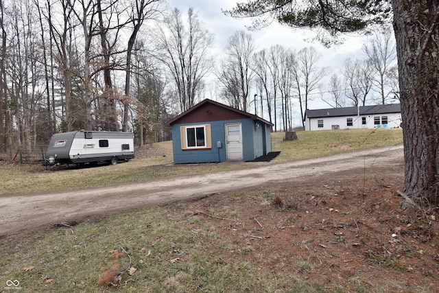 view of outbuilding with dirt driveway and an outdoor structure