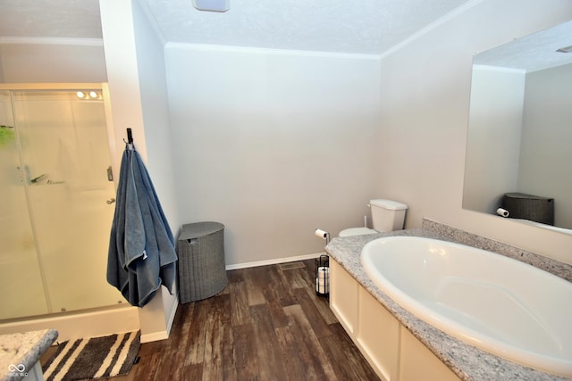 bathroom with a shower stall, crown molding, baseboards, and wood finished floors