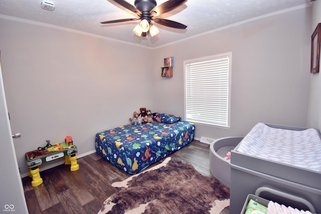 bedroom featuring ornamental molding, ceiling fan, baseboards, and wood finished floors