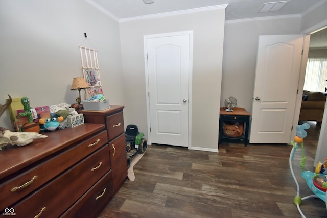 bedroom with baseboards, visible vents, ornamental molding, and dark wood-type flooring