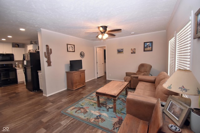 living room featuring a textured ceiling, ceiling fan, dark wood-type flooring, baseboards, and ornamental molding