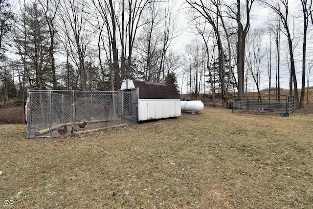 view of yard with an outdoor structure, fence, and exterior structure