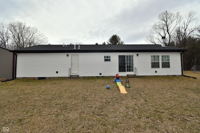 back of house featuring crawl space and a yard