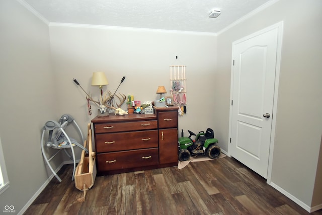 bedroom with dark wood-style floors, crown molding, and baseboards