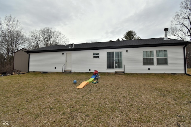 back of house featuring crawl space and a yard