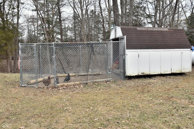 exterior space with an outbuilding and fence