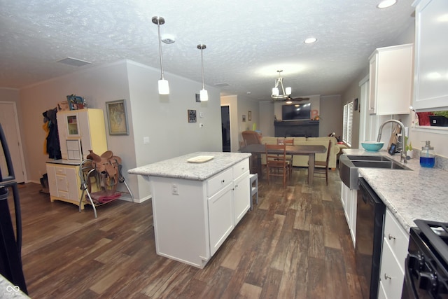 kitchen featuring white cabinets, dark wood-style flooring, a textured ceiling, black appliances, and a sink