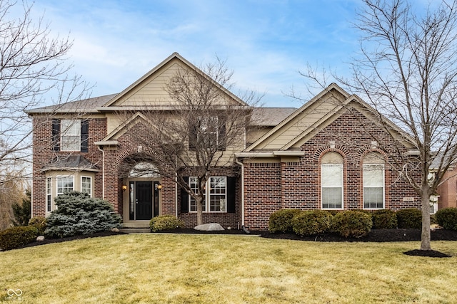 traditional home featuring brick siding and a front lawn