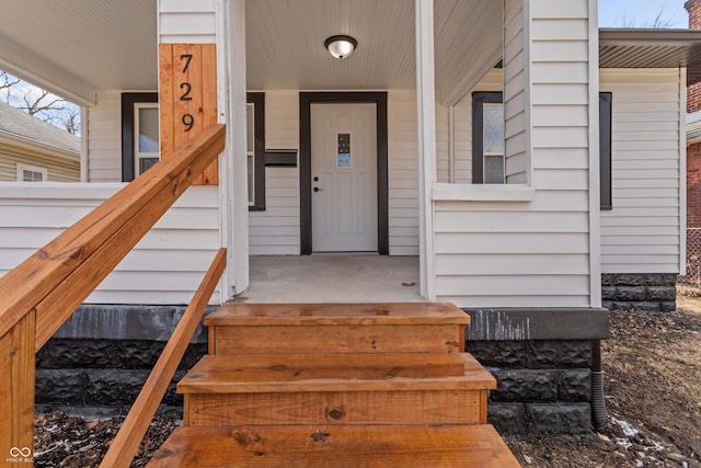 view of exterior entry featuring a porch