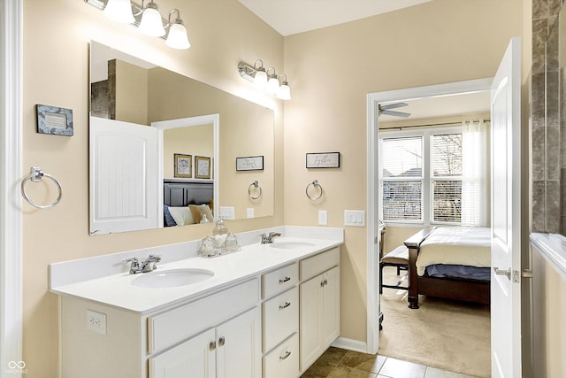 ensuite bathroom with a sink, ensuite bath, double vanity, and tile patterned floors