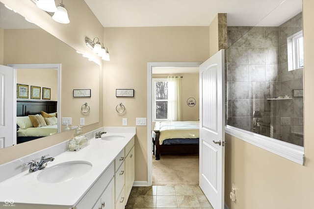 bathroom with tile patterned flooring, ensuite bath, double vanity, and a sink