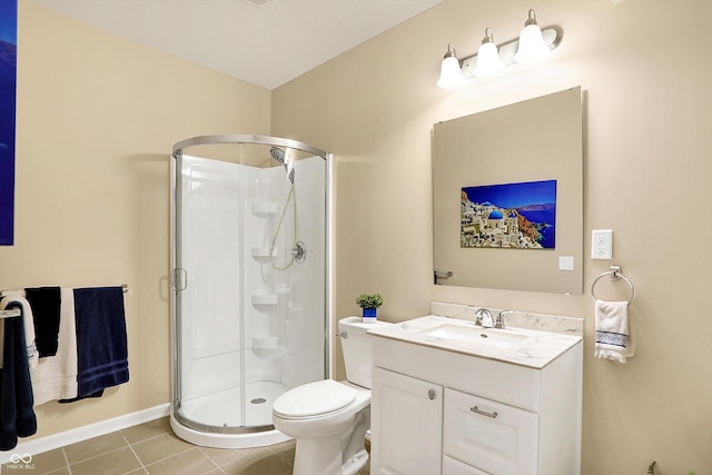 bathroom featuring tile patterned flooring, a shower stall, vanity, and toilet