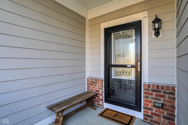 property entrance featuring brick siding