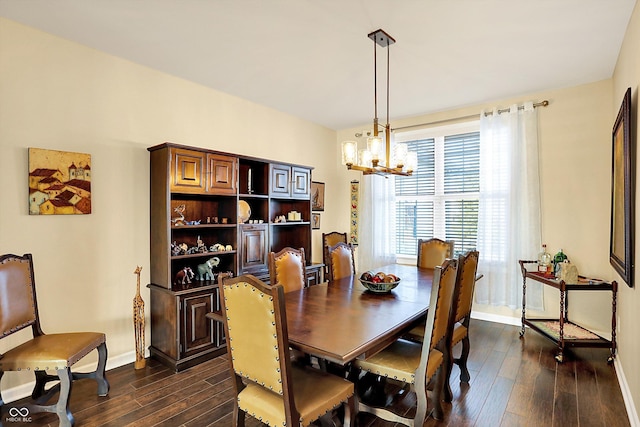 dining area featuring a notable chandelier, dark wood-type flooring, and baseboards