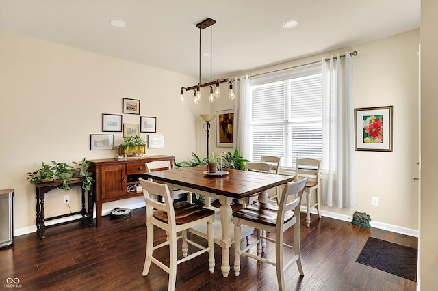 dining space with baseboards and dark wood-type flooring