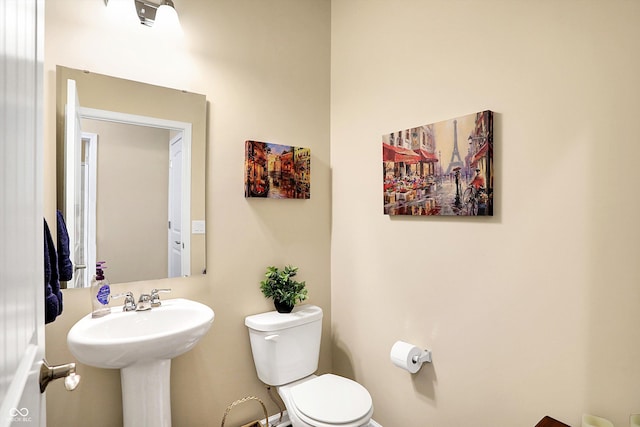 bathroom featuring toilet and a sink