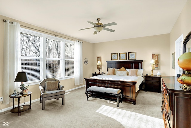 bedroom featuring baseboards, light carpet, and ceiling fan