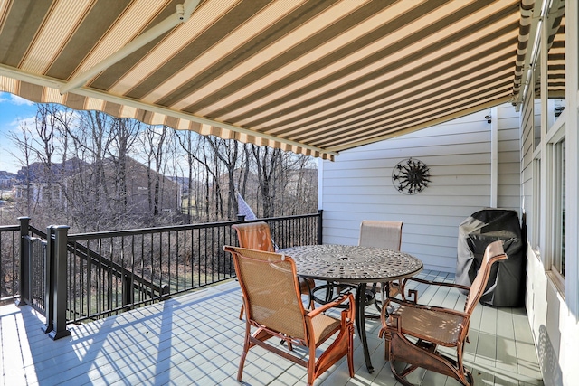 wooden deck featuring grilling area and outdoor dining area