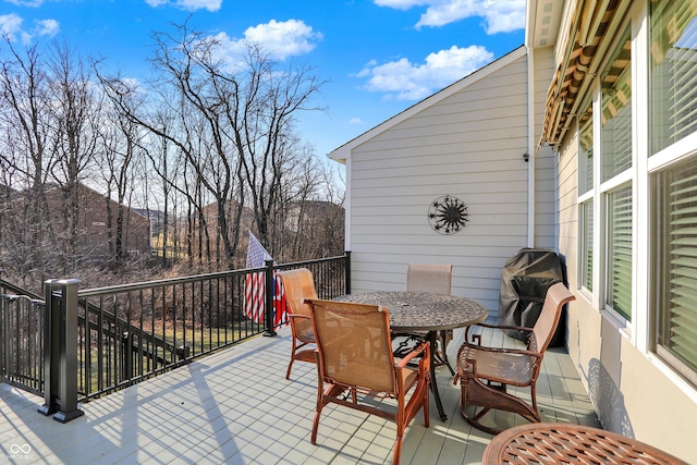 exterior space with a wooden deck and outdoor dining area