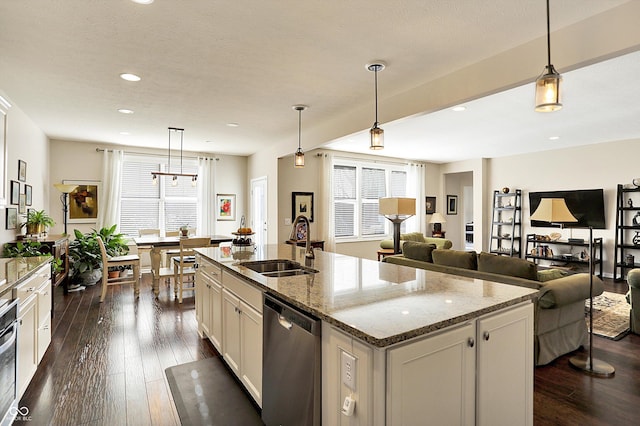 kitchen featuring a sink, a healthy amount of sunlight, dark wood finished floors, and stainless steel appliances