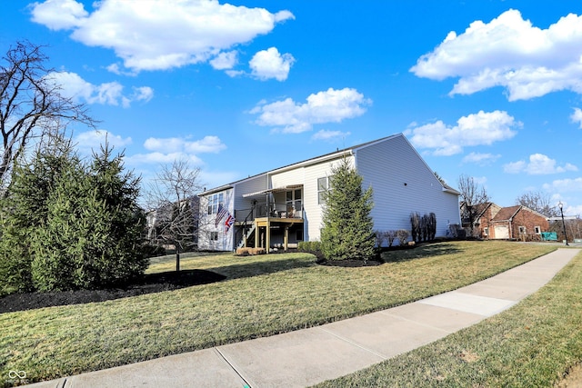 view of property exterior with a deck and a lawn