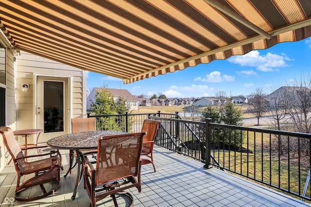 balcony featuring a residential view and outdoor dining area