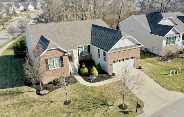 view of front of property featuring brick siding, a residential view, concrete driveway, a front yard, and an attached garage