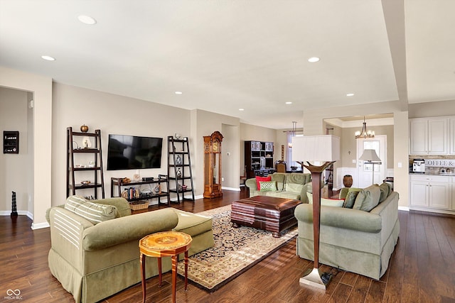 living room with a notable chandelier, dark wood-style floors, recessed lighting, and baseboards