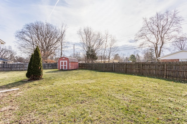 view of yard with a shed, an outdoor structure, and a fenced backyard