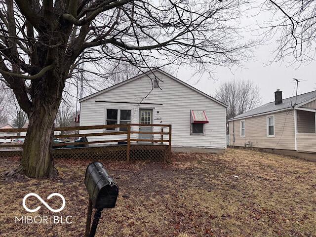 back of property with a wooden deck