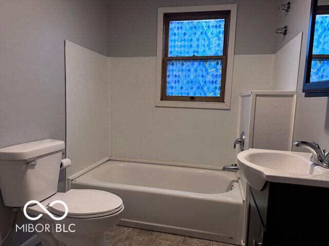 full bathroom featuring tile patterned flooring, vanity, toilet, and shower / bathtub combination