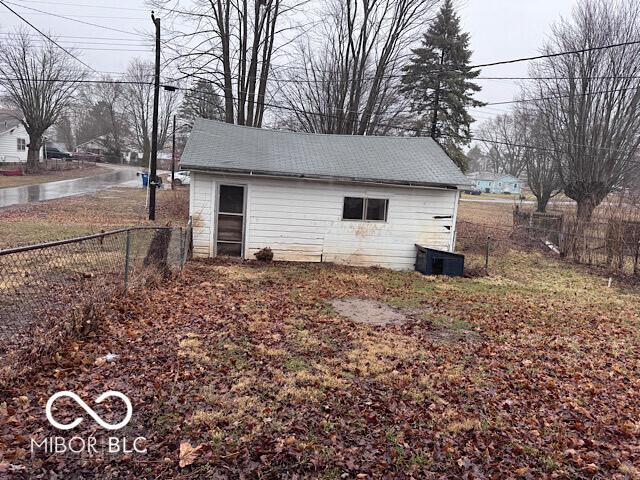 view of outdoor structure with fence and central AC unit