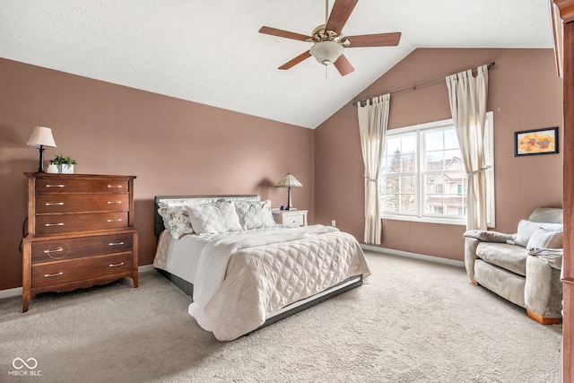 carpeted bedroom featuring ceiling fan, baseboards, and vaulted ceiling