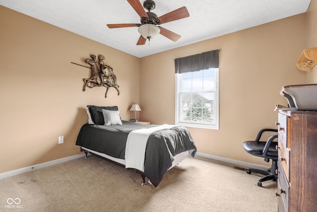 bedroom featuring carpet floors, baseboards, and a textured ceiling