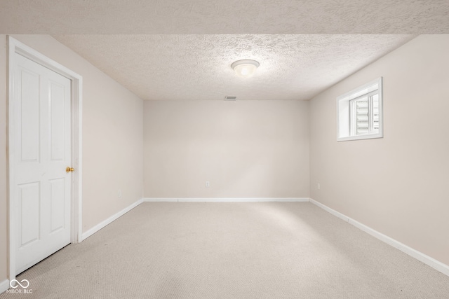 unfurnished room with light carpet, visible vents, and baseboards