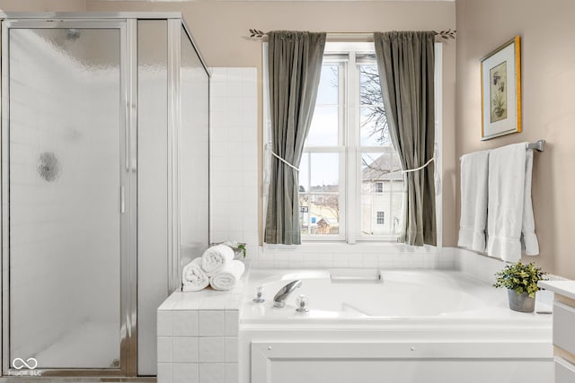 full bathroom with vanity, a shower stall, and a bath