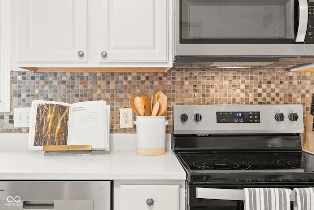 kitchen with stainless steel appliances, light countertops, white cabinets, and tasteful backsplash