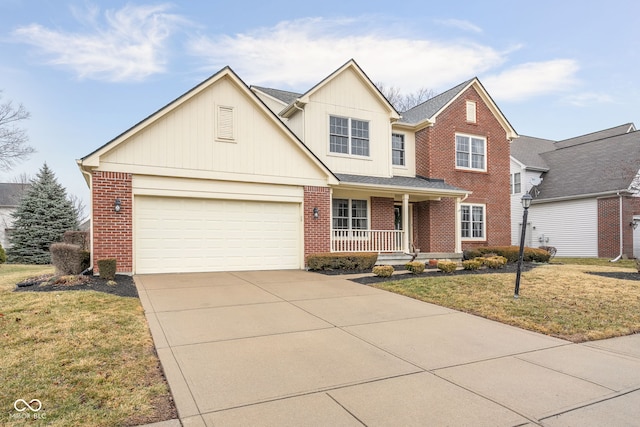 traditional-style home with driveway, a porch, a front yard, and brick siding