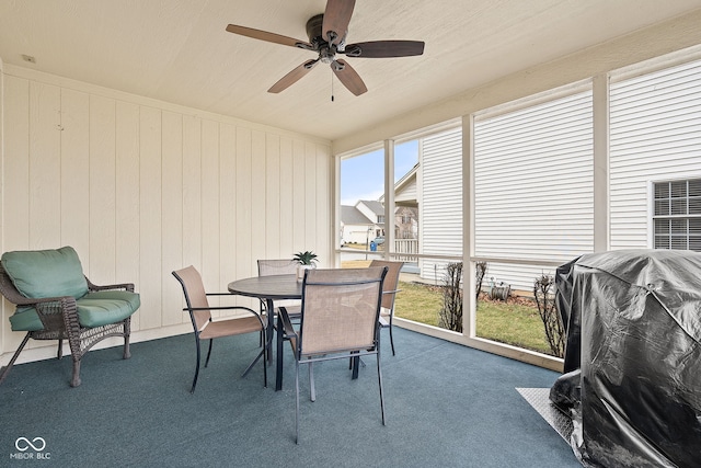 sunroom / solarium featuring ceiling fan