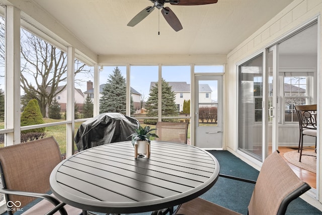 sunroom / solarium with plenty of natural light and a ceiling fan