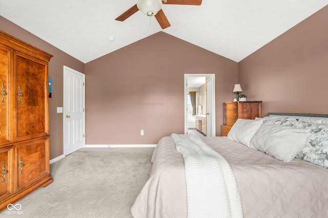 bedroom with lofted ceiling, connected bathroom, light colored carpet, a ceiling fan, and baseboards