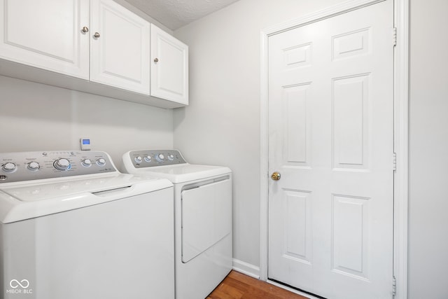11866 Weathered Edge Dr, Fishers, IN 46037 - clothes washing area featuring independent washer and dryer, cabinet space, wood finished floors, and baseboards