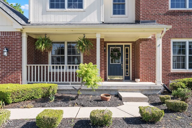 11866 Weathered Edge Dr, Fishers, IN 46037 - entrance to property featuring brick siding, a porch, and board and batten siding