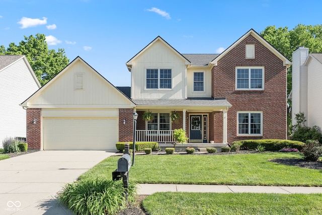 11866 Weathered Edge Dr, Fishers, IN 46037 - view of front of property featuring covered porch, concrete driveway, a front yard, a garage, and brick siding