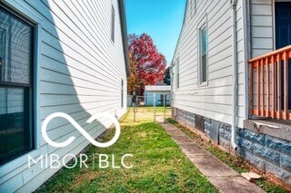 view of side of property with a yard