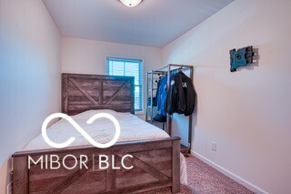 bedroom featuring baseboards and carpet flooring